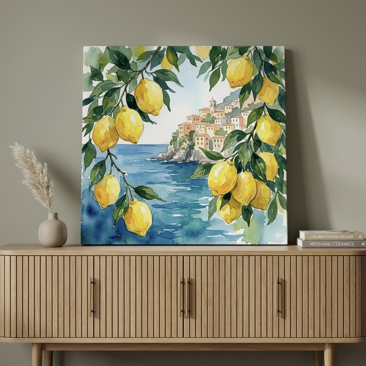 Amalfi Coast lemon watercolor canvas with yellow lemons, blue sea, and white village hung above a white kitchen island and rattan stools